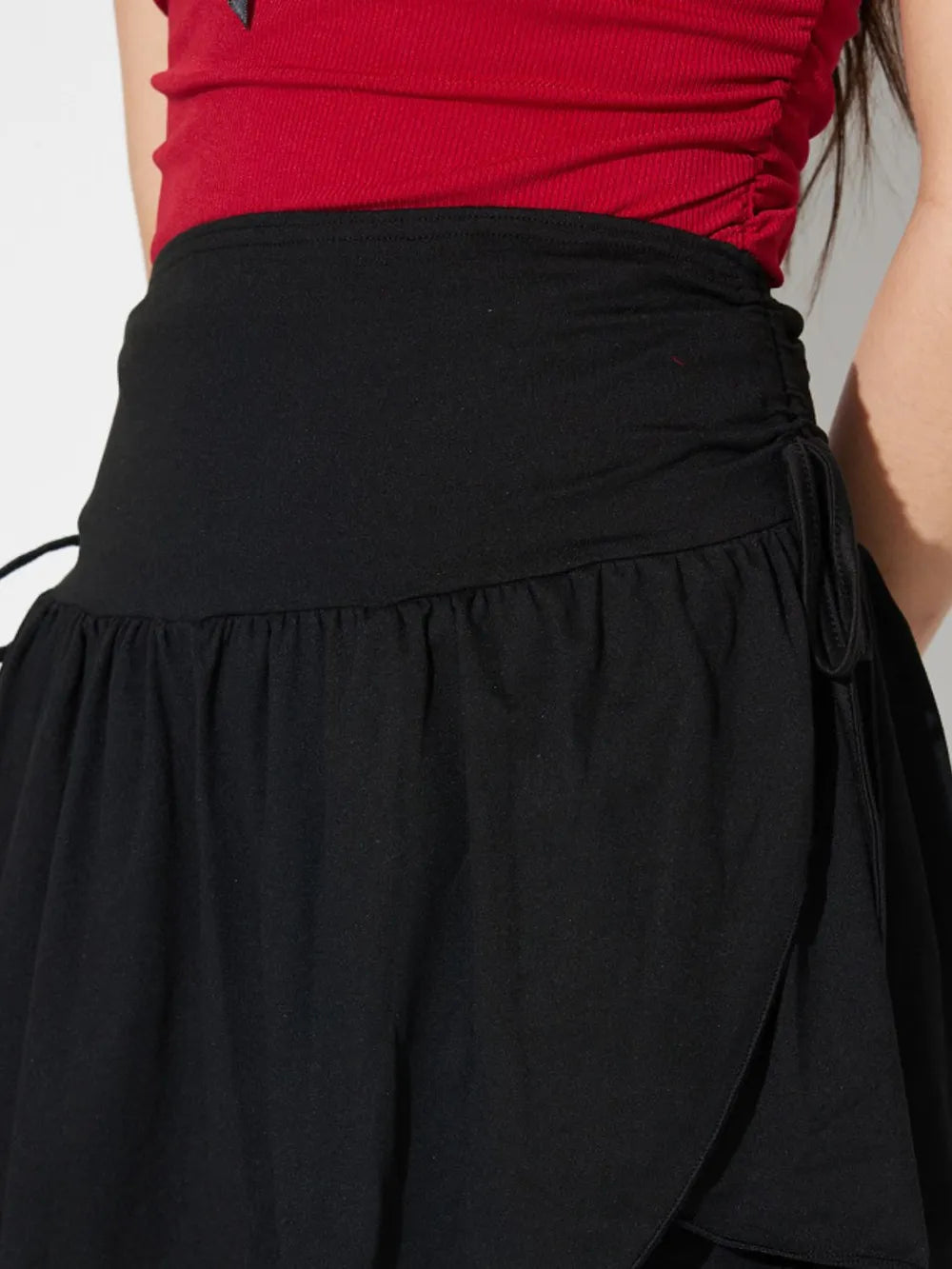 Side-Tie Asymmetric Hem Mini Skirt in Black