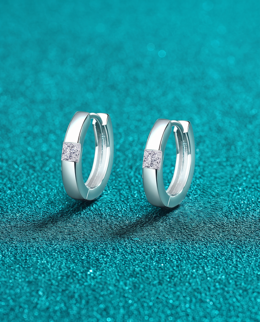 Pair of silver hoop earrings with a single square stone at the hinge