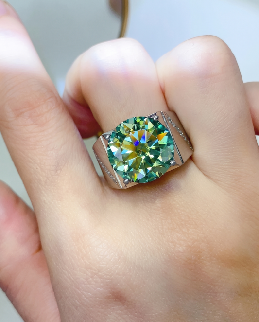 Silver signet ring with a large faceted stone, worn on a finger, close-up front view.